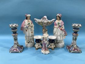 A German porcelain table centrepiece, a German figure of a lady, a pair of Staffordshire figures