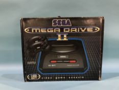 A boxed Sega Mega Drive II game console