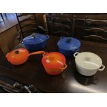 Three Le Creuset pans and two others