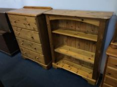 A pine chest of drawers and a bookcase