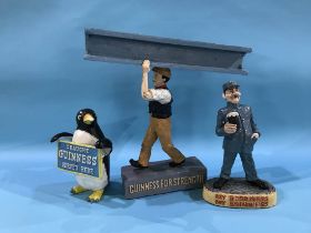 Three Guinness advertising figures