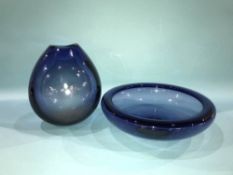A Holmegaard blue glass shallow circular bowl and a matching Holmegaard blue drop vase signed Per