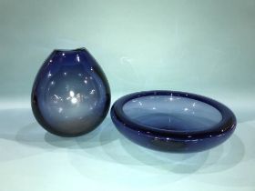 A Holmegaard blue glass shallow circular bowl and a matching Holmegaard blue drop vase signed Per