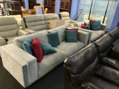 A pale grey upholstered four seater settee and a two seater settee