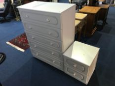 A white chest of drawers and bedside drawers
