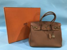 Boxed brown leather handbag, with dust bag and lock and key