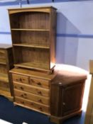 A pine chest of drawers, a pine bookcase and a corner cabinet