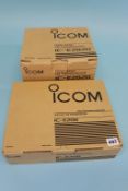 A boxed ICOM E208 transceiver and a boxed ICOM IC - E2820 dual band transceiver