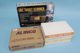 Two boxed Aircroft band receivers R535, an Alinco DJ - MD5, and a trunk tracker III UBC 780 XLT,