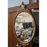 Oval gilt mirror with ceramic plaque