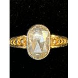 Yellow metal ring set with large crystal gem stone
