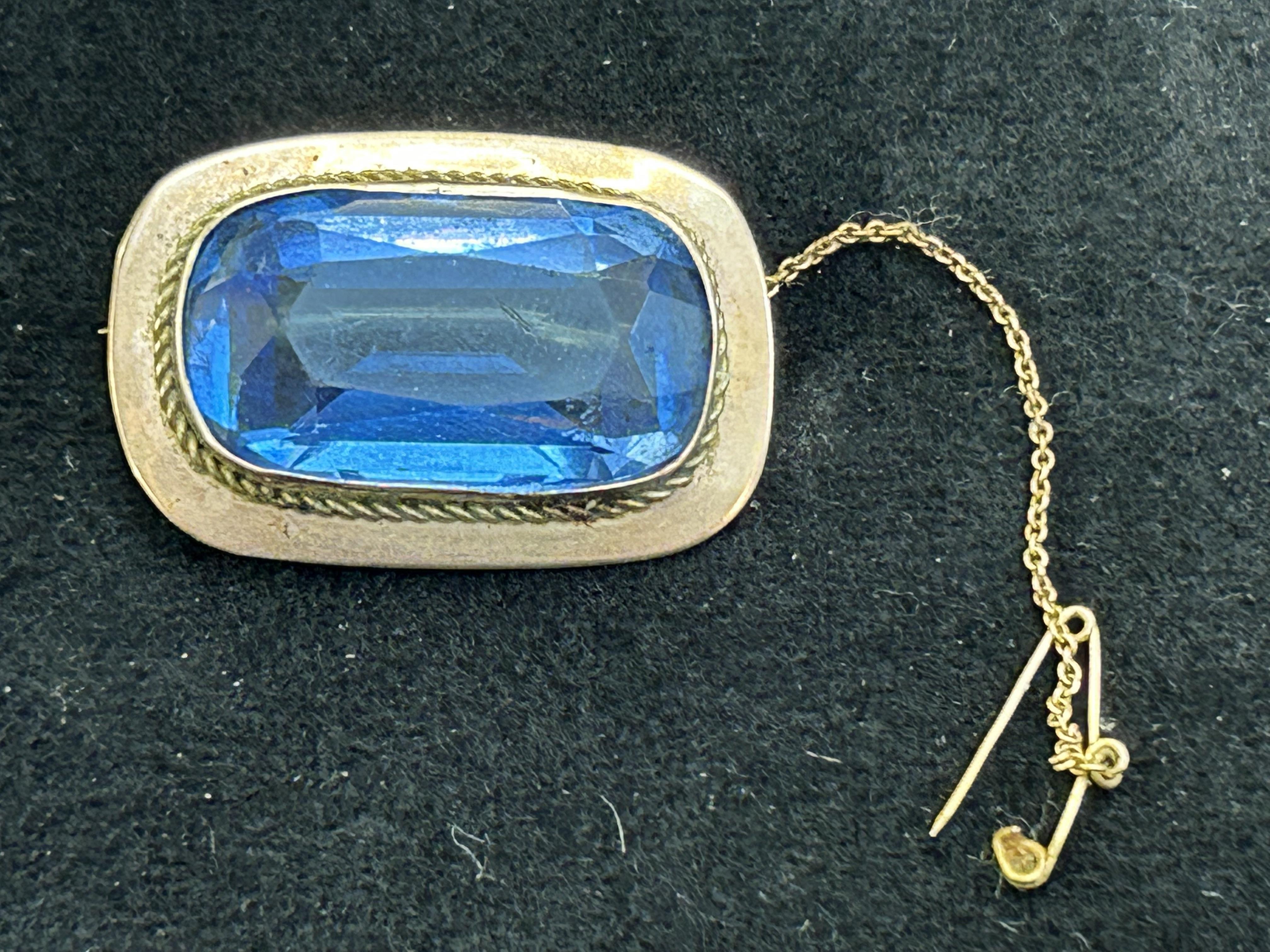 9ct gold brooch with large blue paste stone signed