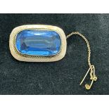 9ct gold brooch with large blue paste stone signed