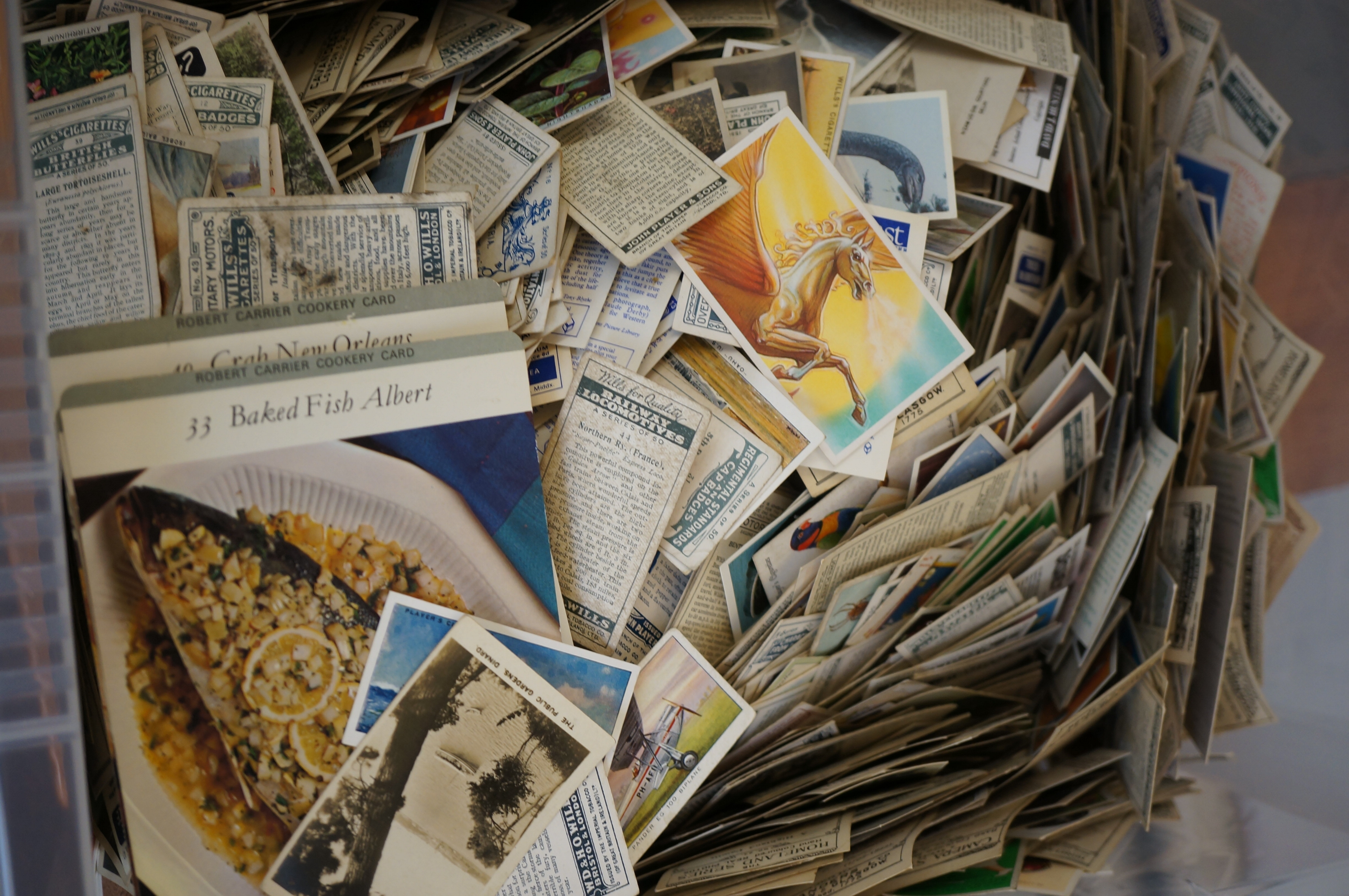Large box of unsorted cigarette cards