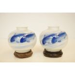 Pair of oriental blue & white vases on wooden stan