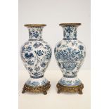 Pair of blue & white vases with bronze base & rim