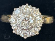 18ct Gold set with 8 diamonds surrounding central