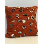 Cushion of brooches