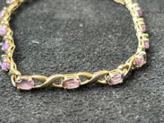 9ct Gold bracelet set with 16 purple stones