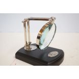 Chrome magnifying glass on wooden base