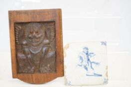 Early possibly Delft tile together with a wooden p