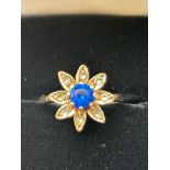 9ct Gold flower design ring set with blue stone &