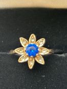 9ct Gold flower design ring set with blue stone &