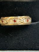 9ct Gold eternity ring set with red garnets & cz s