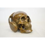 Bronze skull wearing headphones
