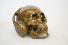 Bronze skull wearing headphones