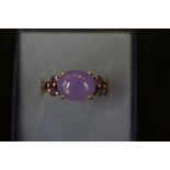 Silver ring set with 6 small purple stones & large