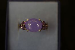 Silver ring set with 6 small purple stones & large