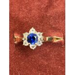 9ct Gold ring set with central sapphire surrounded