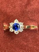 9ct Gold ring set with central sapphire surrounded