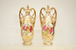 Pair of continental twin handled lidded vases