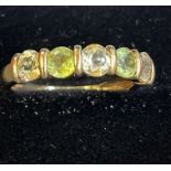 9ct gold ring set with peridot and white stones Si