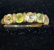 9ct gold ring set with peridot and white stones Si