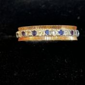 9ct gold eternity ring set with white and blue sto