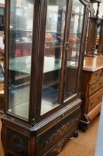 A large French style display cabinet with drawer