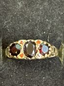 9ct gold ring set with 3 garnets and 4 small rubie