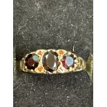 9ct gold ring set with 3 garnets and 4 small rubie