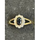 9ct gold ring set with central sapphire surrounded
