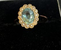 9ct gold ring set with central aqua marine and pea