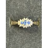 9ct gold ring set with 3 blue stones surrounded by