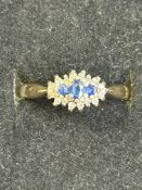 9ct gold ring set with 3 blue stones surrounded by