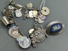 Charm bracelet with some silver charms together with a silver cameo brooch
