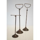 A good pair of late 19th century/early 20th century telescopic cast metal shop display or hat stands