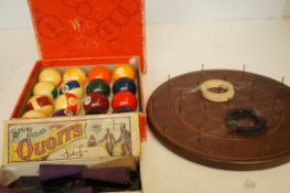An early hula hoop, set of balls and a spring heel