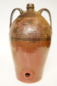 A large and heavy terracotta wine or oil dispenser