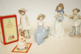 Four Nao figurines together with a Royal Doulton B